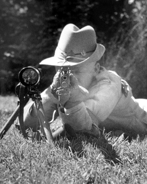 Donald Smith Fraser with his rifle and telescope.