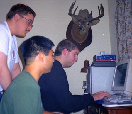 Chris Jones, Patrick Lam and Mathieu Fenniak working on Moo Canada while the deer looks on.