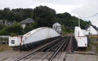 [Railway bridge with control box in background]