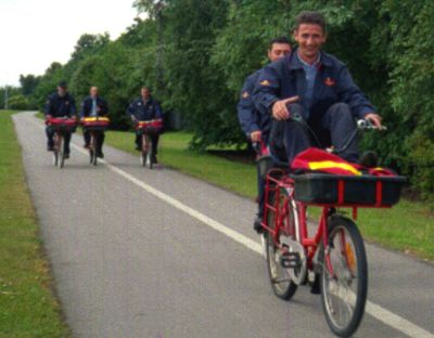 [Postal workers on bicycles]